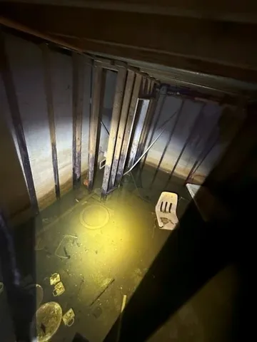 a view of a room with table and chairs