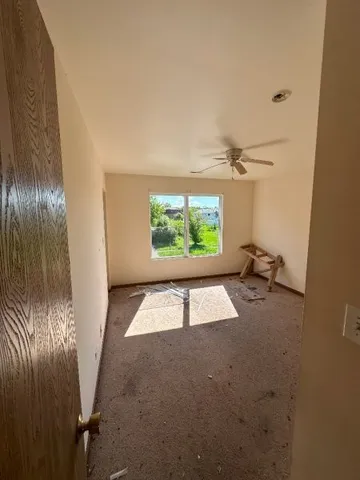 a view of a room with wooden floor and window