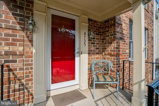 a living room with furniture a flat screen tv and wooden floor