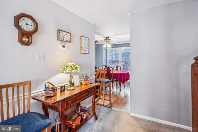 a kitchen with stainless steel appliances granite countertop a stove a refrigerator a dining table and chairs with wooden floor