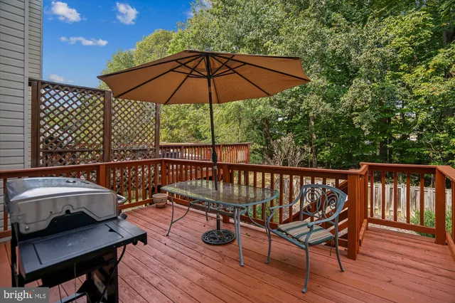 a view of balcony with wooden floor and outdoor seating