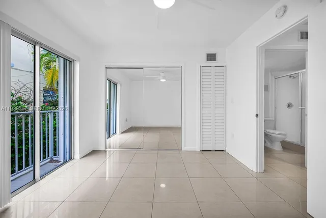 a view of an entryway with wooden floor and a cabinet