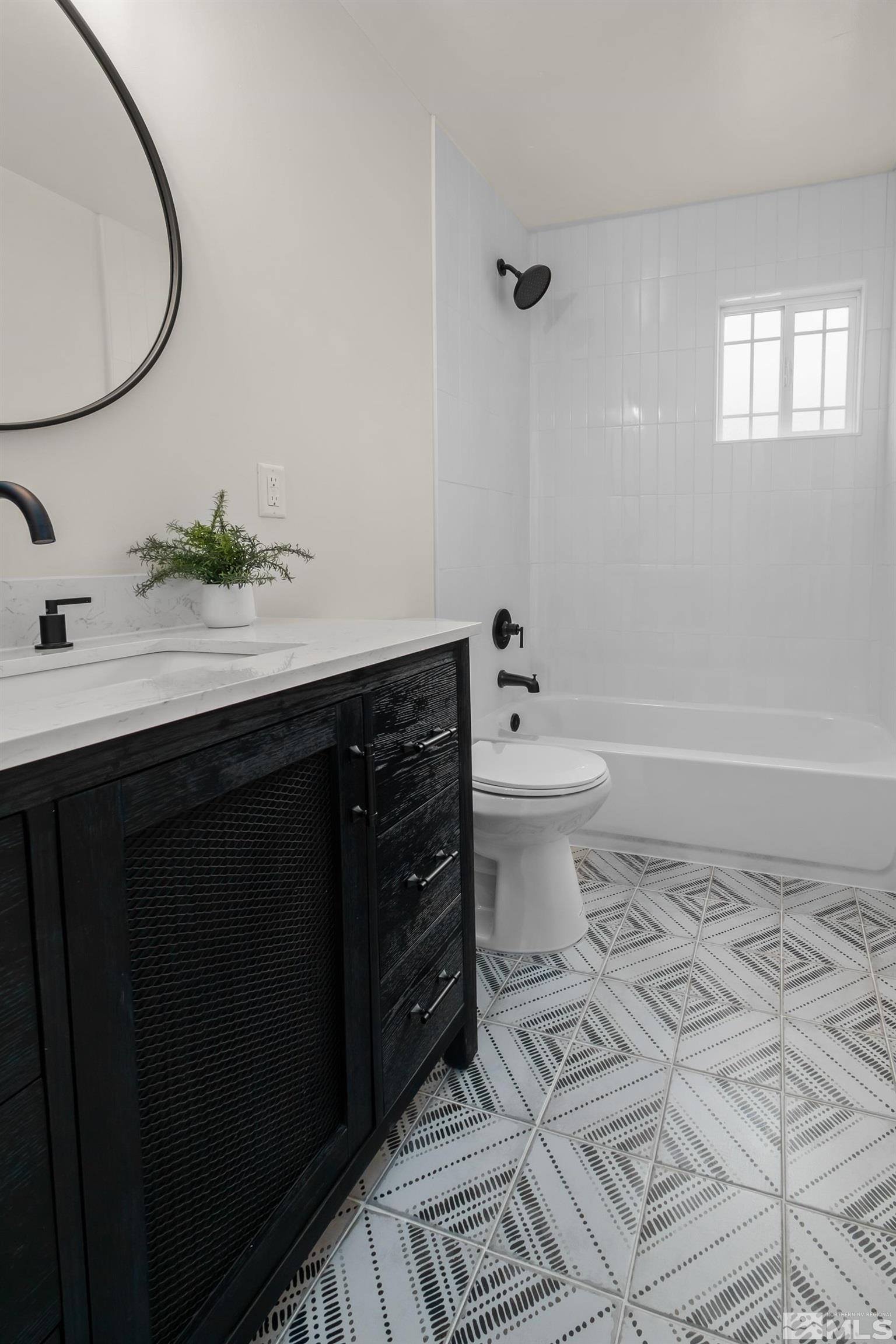 1220 Vassar Street Reno, NV 89502 - Photo 12 of 36 a bathroom with a sink a toilet and a mirror