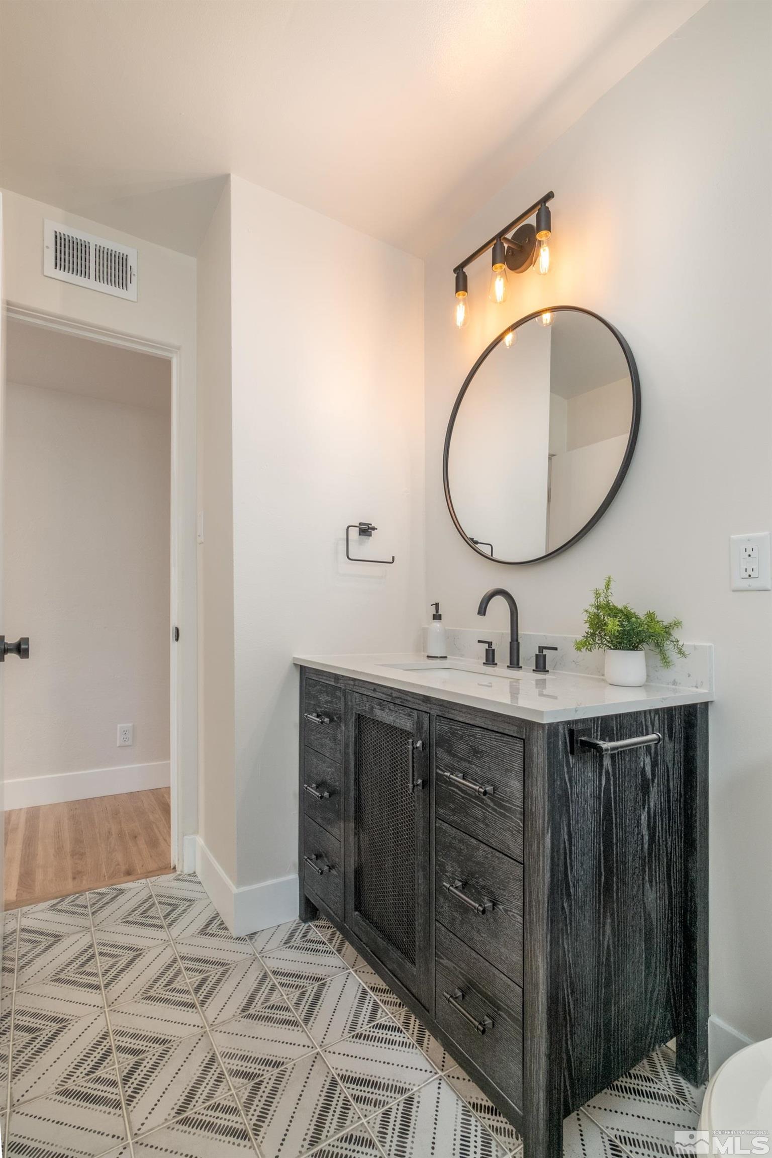 1220 Vassar Street Reno, NV 89502 - Photo 13 of 36 a bathroom with a double vanity sink and a mirror