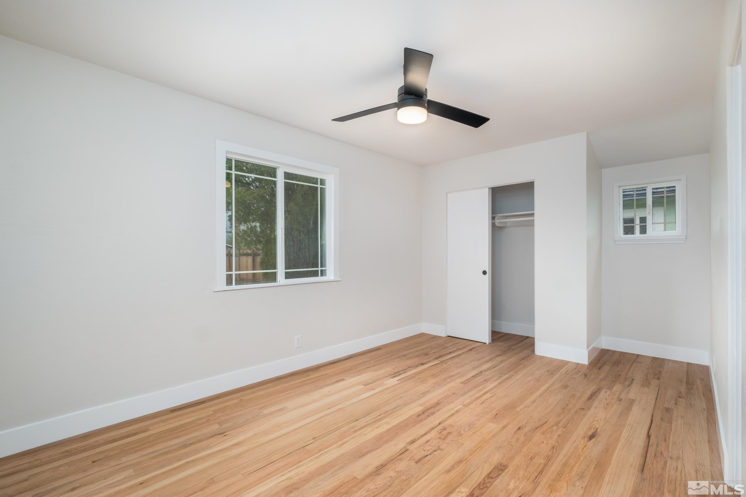 1220 Vassar Street Reno, NV 89502 - Photo 15 of 36 a view of empty room with wooden floor and fan