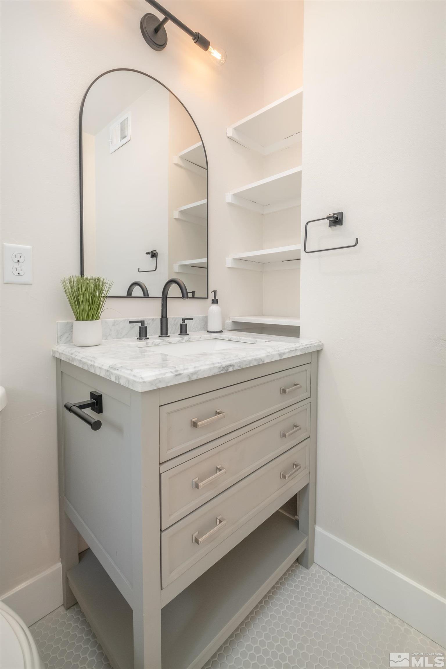 1220 Vassar Street Reno, NV 89502 - Photo 16 of 36 a bathroom with a sink and a mirror