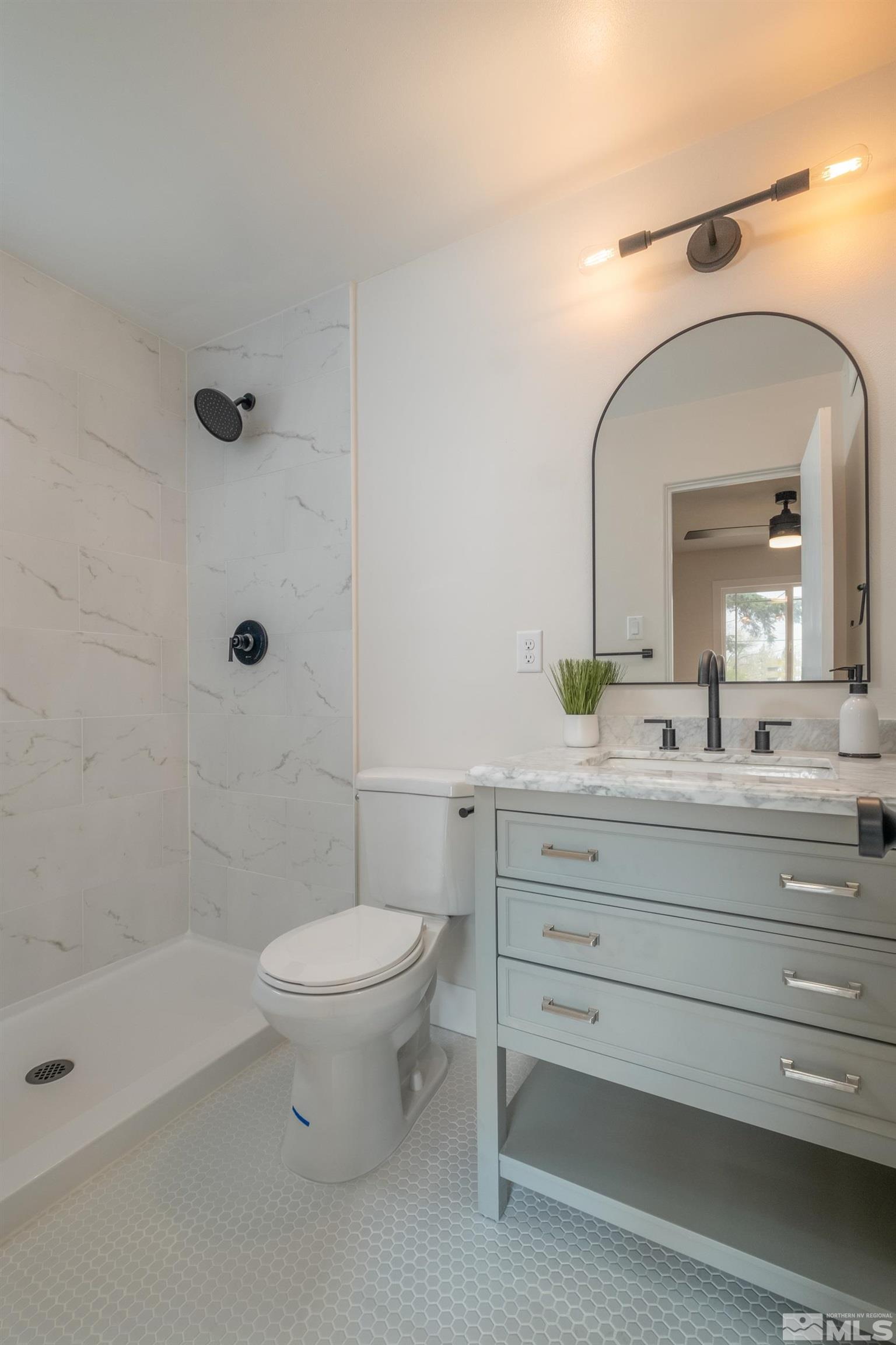 1220 Vassar Street Reno, NV 89502 - Photo 17 of 36 a bathroom with a toilet a sink and mirror