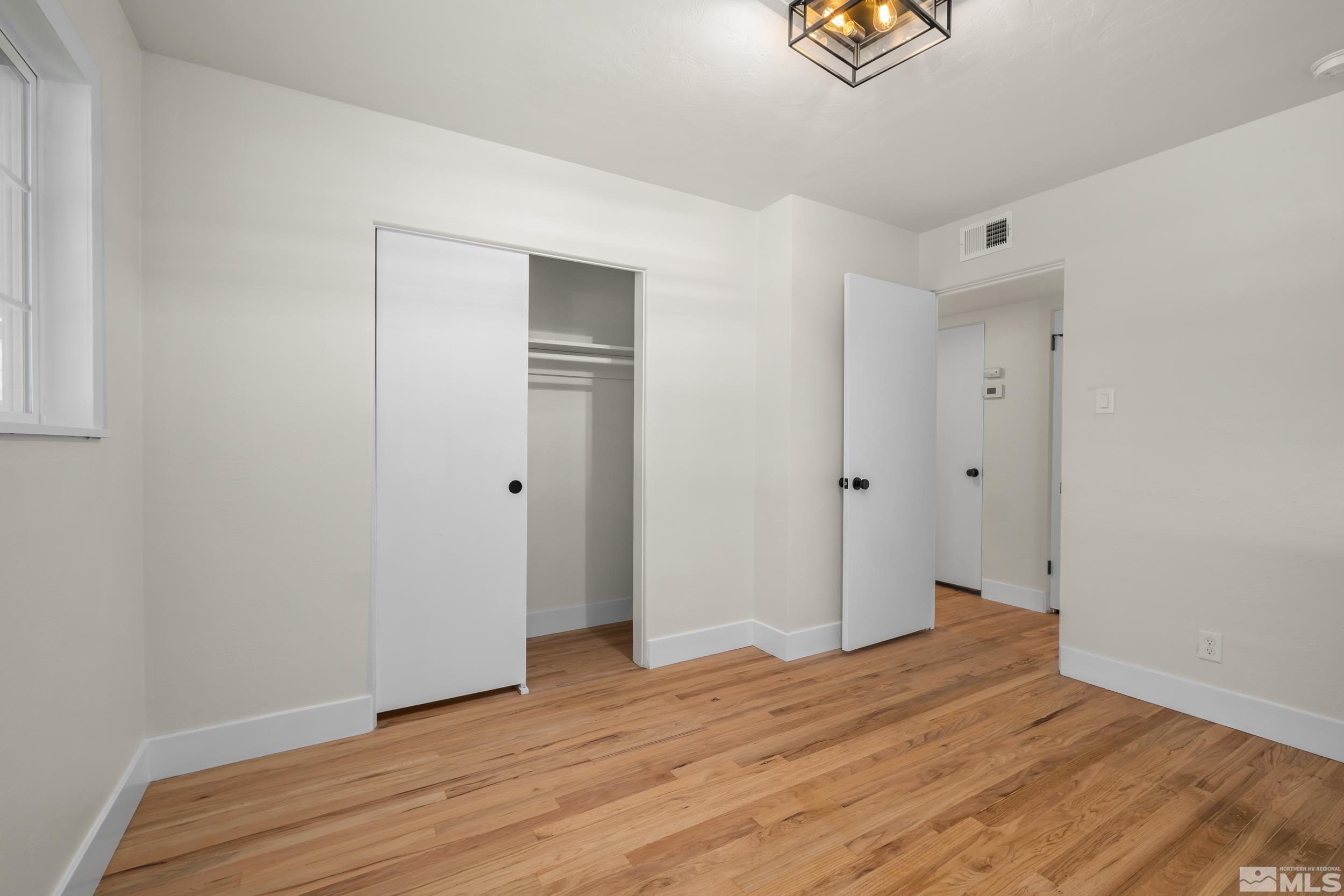 1220 Vassar Street Reno, NV 89502 - Photo 18 of 36 a view of empty room with wooden floor
