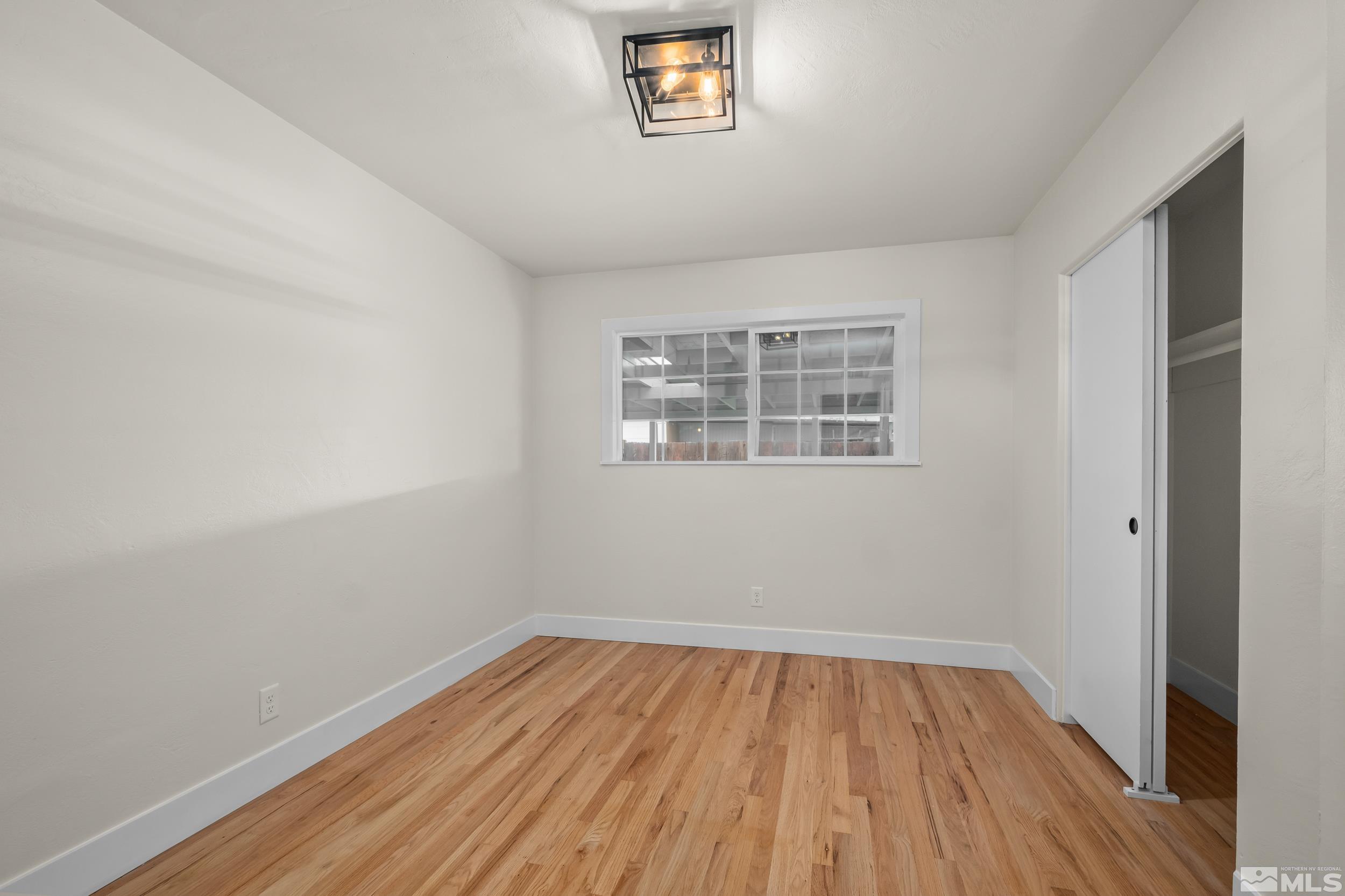 1220 Vassar Street Reno, NV 89502 - Photo 20 of 36 wooden floor in an empty room with a window