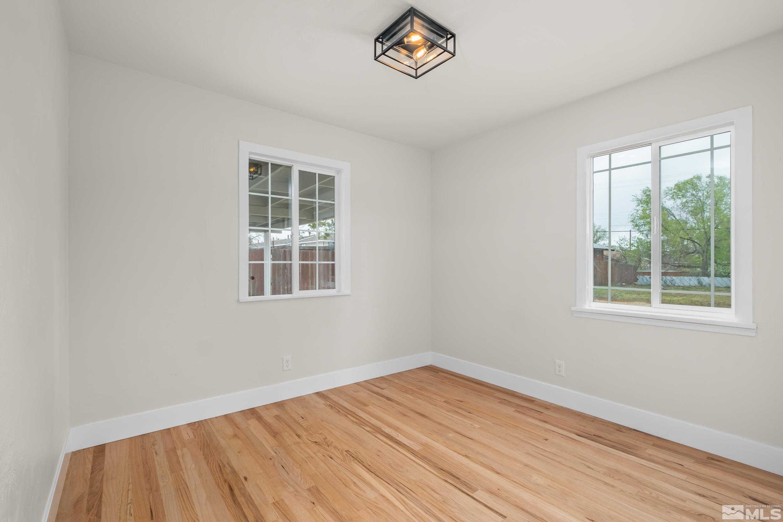 1220 Vassar Street Reno, NV 89502 - Photo 22 of 36 a view of empty room with wooden floor and fan
