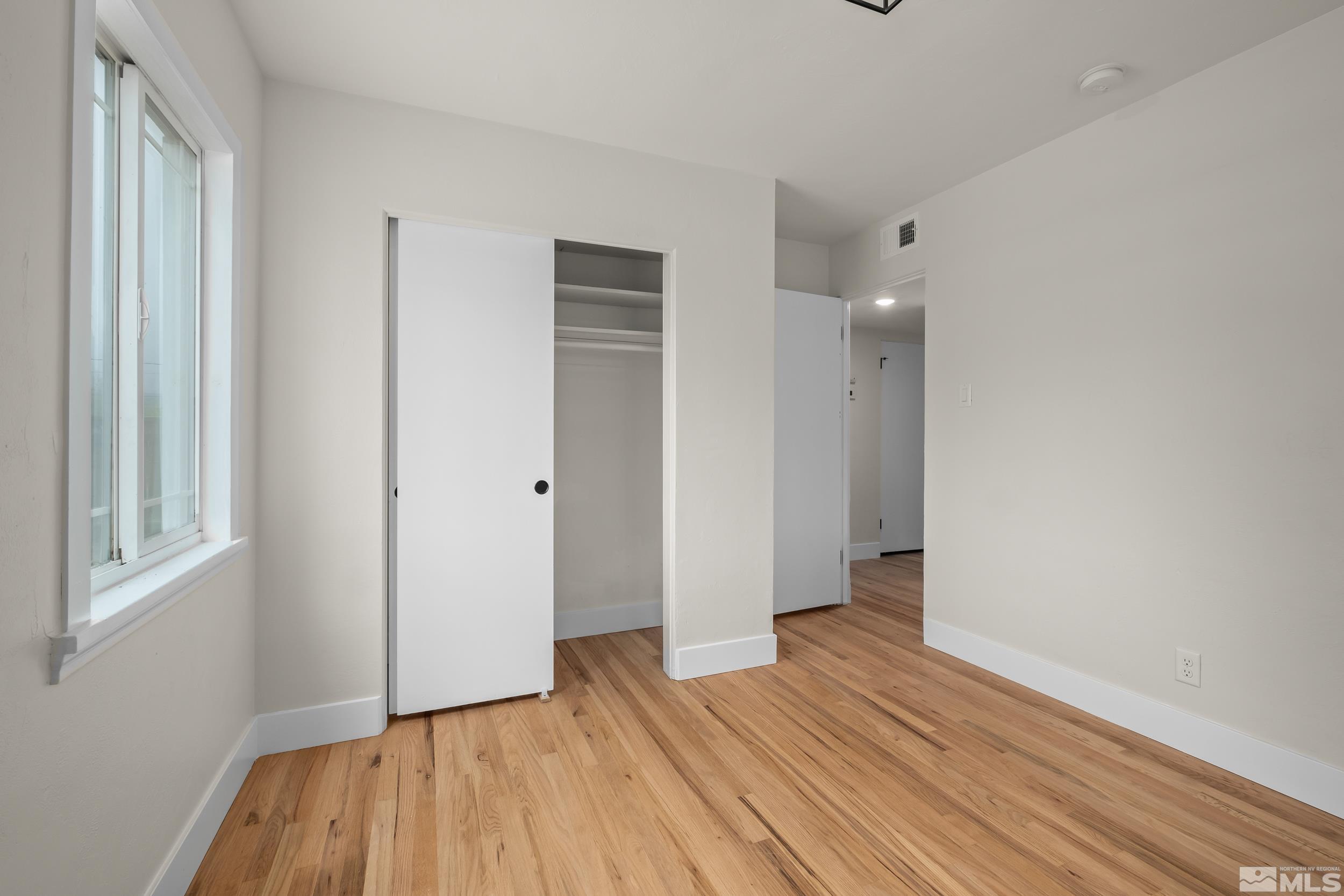1220 Vassar Street Reno, NV 89502 - Photo 23 of 36 a view of an empty room with wooden floor and a window