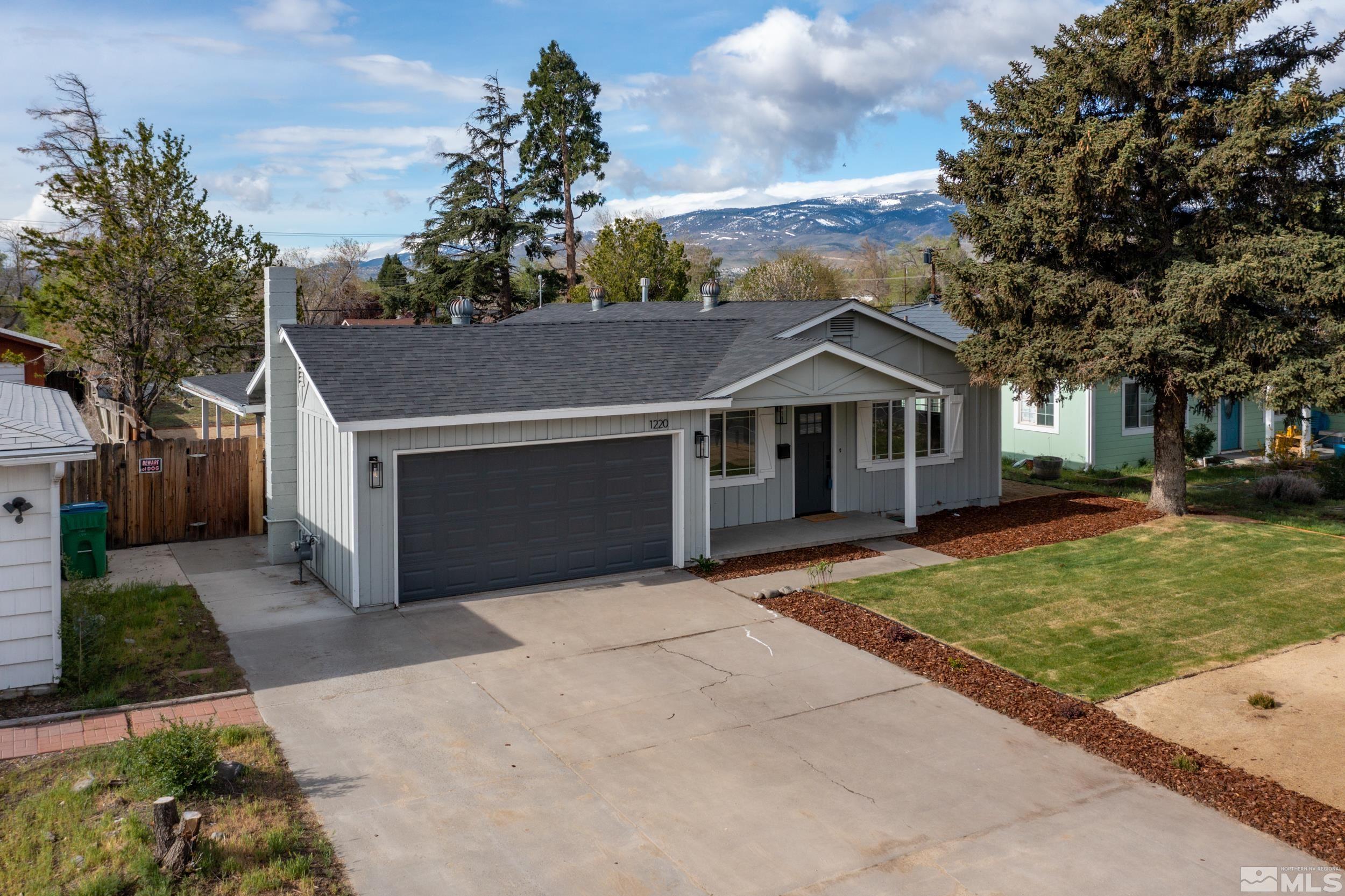 1220 Vassar Street Reno, NV 89502 - Photo 36 of 36 a front view of a house with a garden and tree