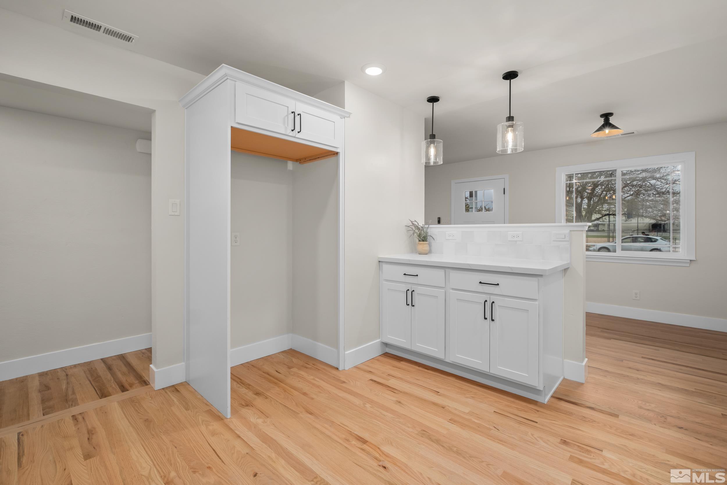 1220 Vassar Street Reno, NV 89502 - Photo 6 of 36 a kitchen with a sink cabinets and wooden floor