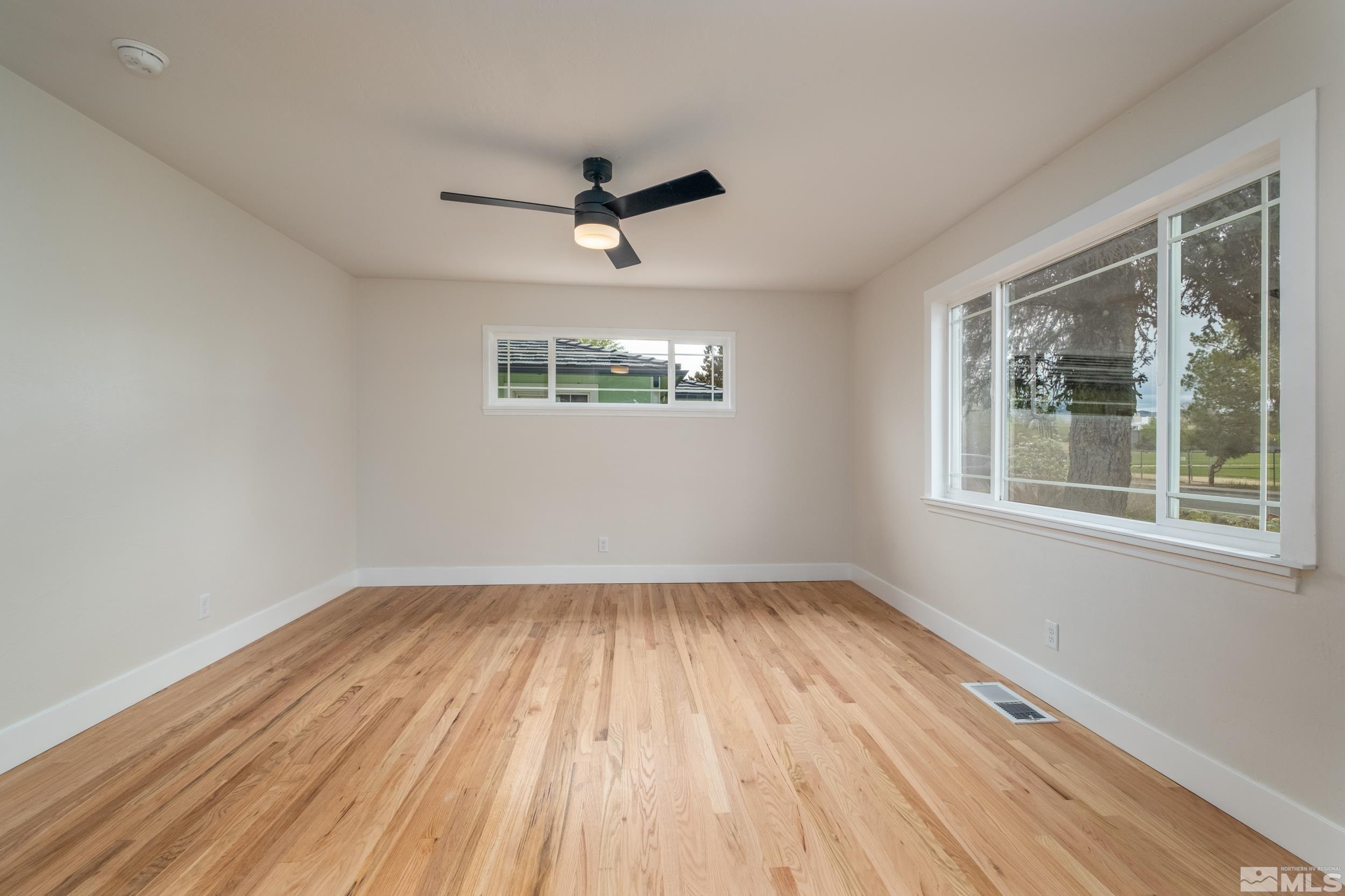 1220 Vassar Street Reno, NV 89502 - Photo 8 of 36 a view of empty room with wooden floor and fan