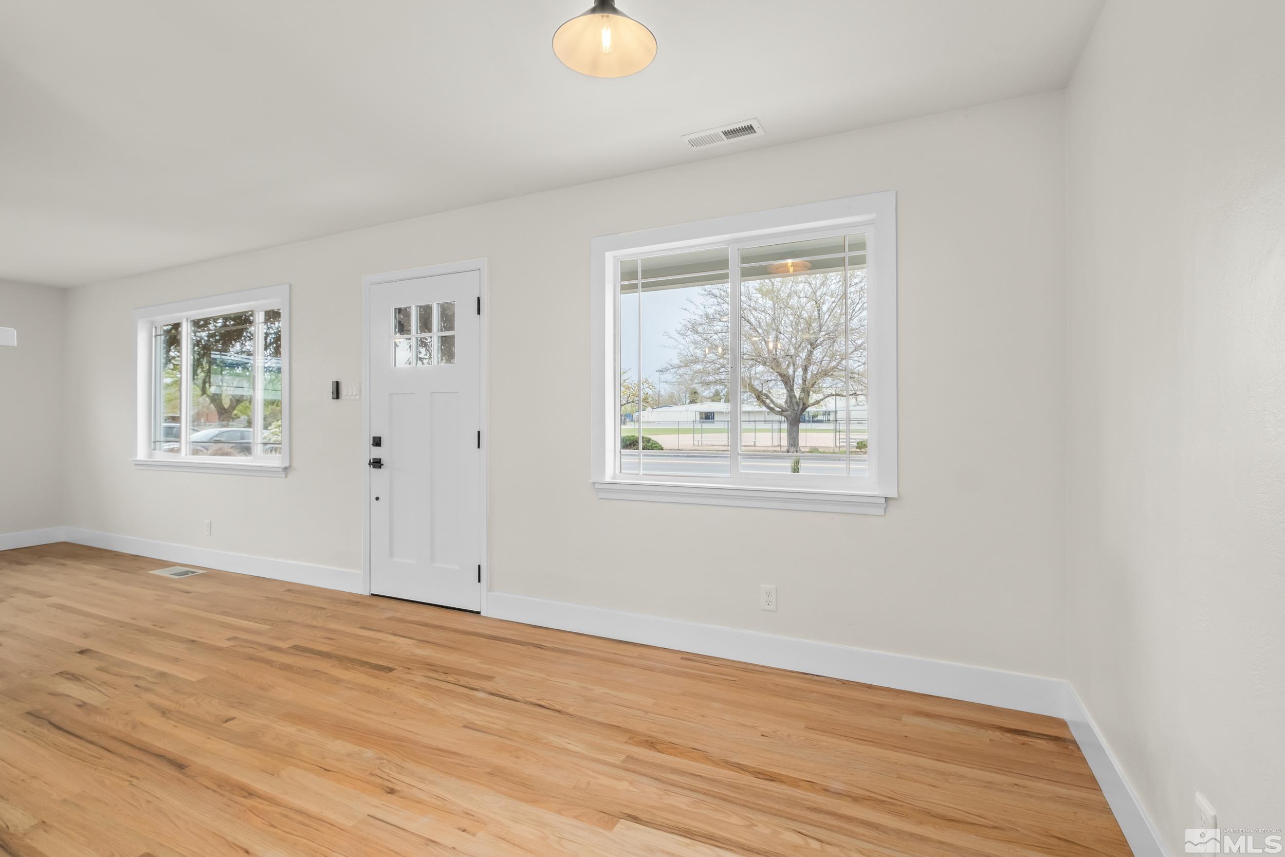 1220 Vassar Street Reno, NV 89502 - Photo 9 of 36 a view of an empty room with wooden floor and a window