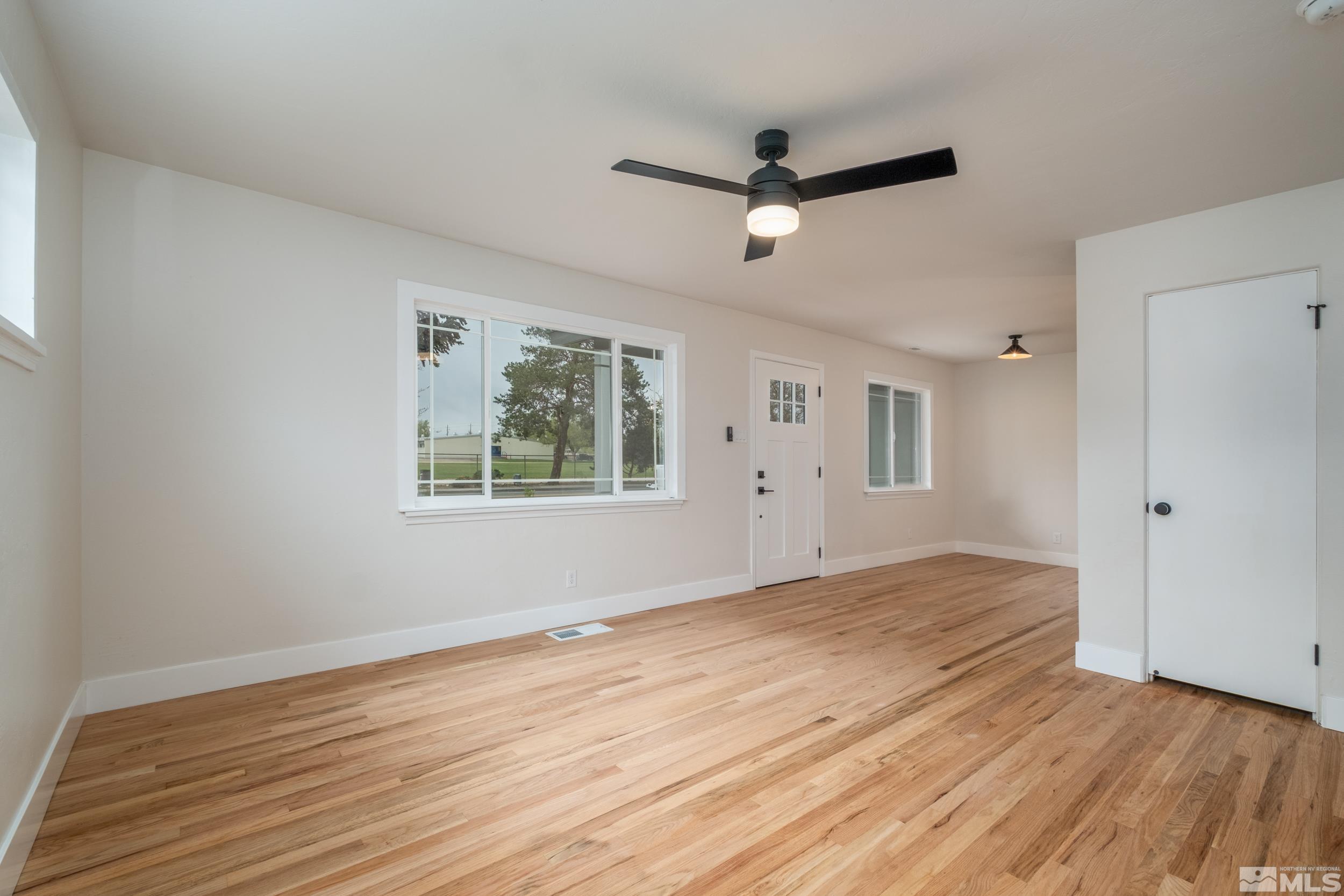 1220 Vassar Street Reno, NV 89502 - Photo 10 of 36 a view of empty room with wooden floor and fan