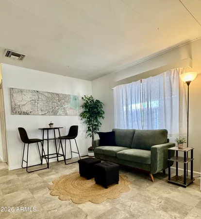 a living room with furniture and a large window