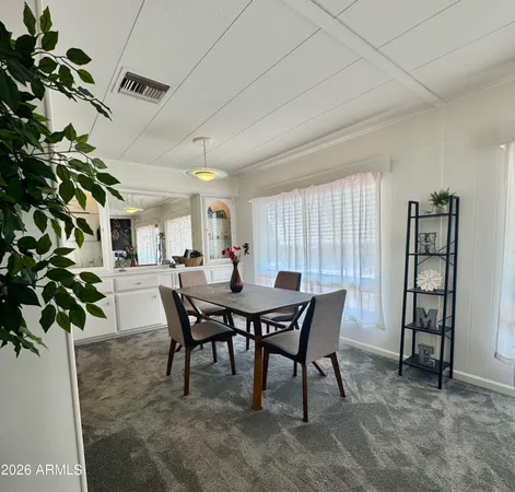 a view of a dining room with furniture and window