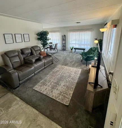 a living room with furniture rug and a window
