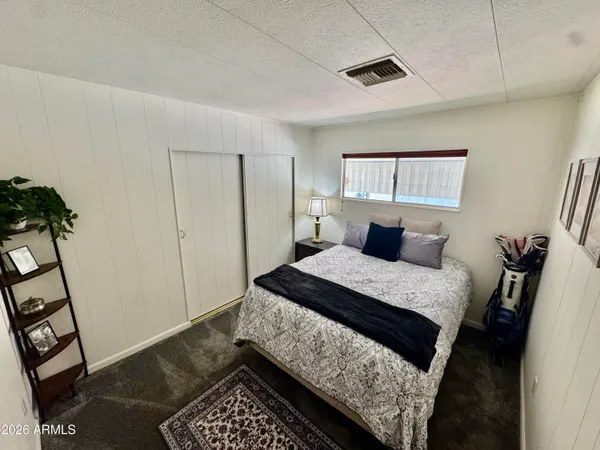 a bedroom with a bed and a window