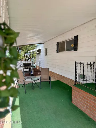 a backyard of a house with table and chairs