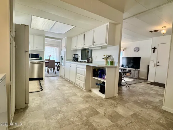 a kitchen with stainless steel appliances a refrigerator sink and cabinets