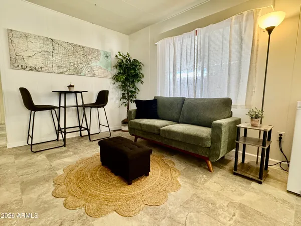 a living room with furniture and a large window