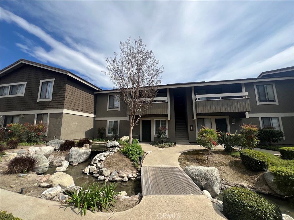 306 Streamwood Irvine, CA 92620 - Photo 1 of 1 a front view of a house with a large tree in it