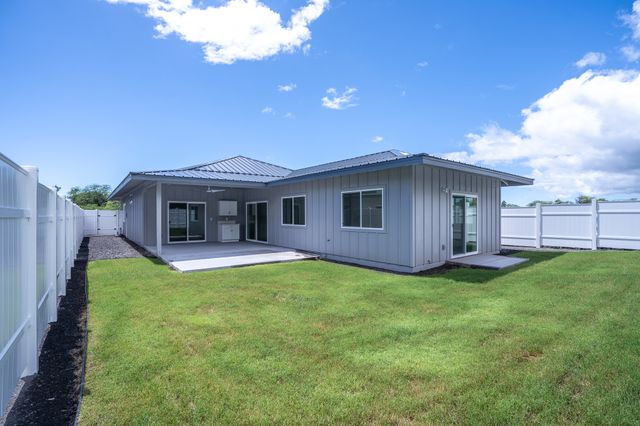 a view of a house with a yard and a patio