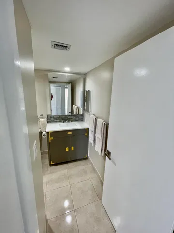 a spacious bathroom with a sink a mirror and a bathtub