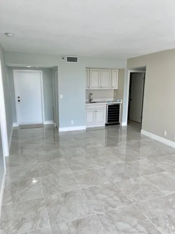 a view of a kitchen with a sink and cabinets
