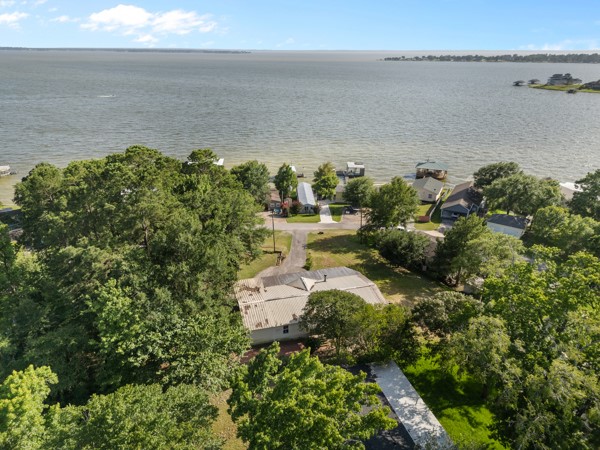 a view of a lake with a yard and mountain in the back