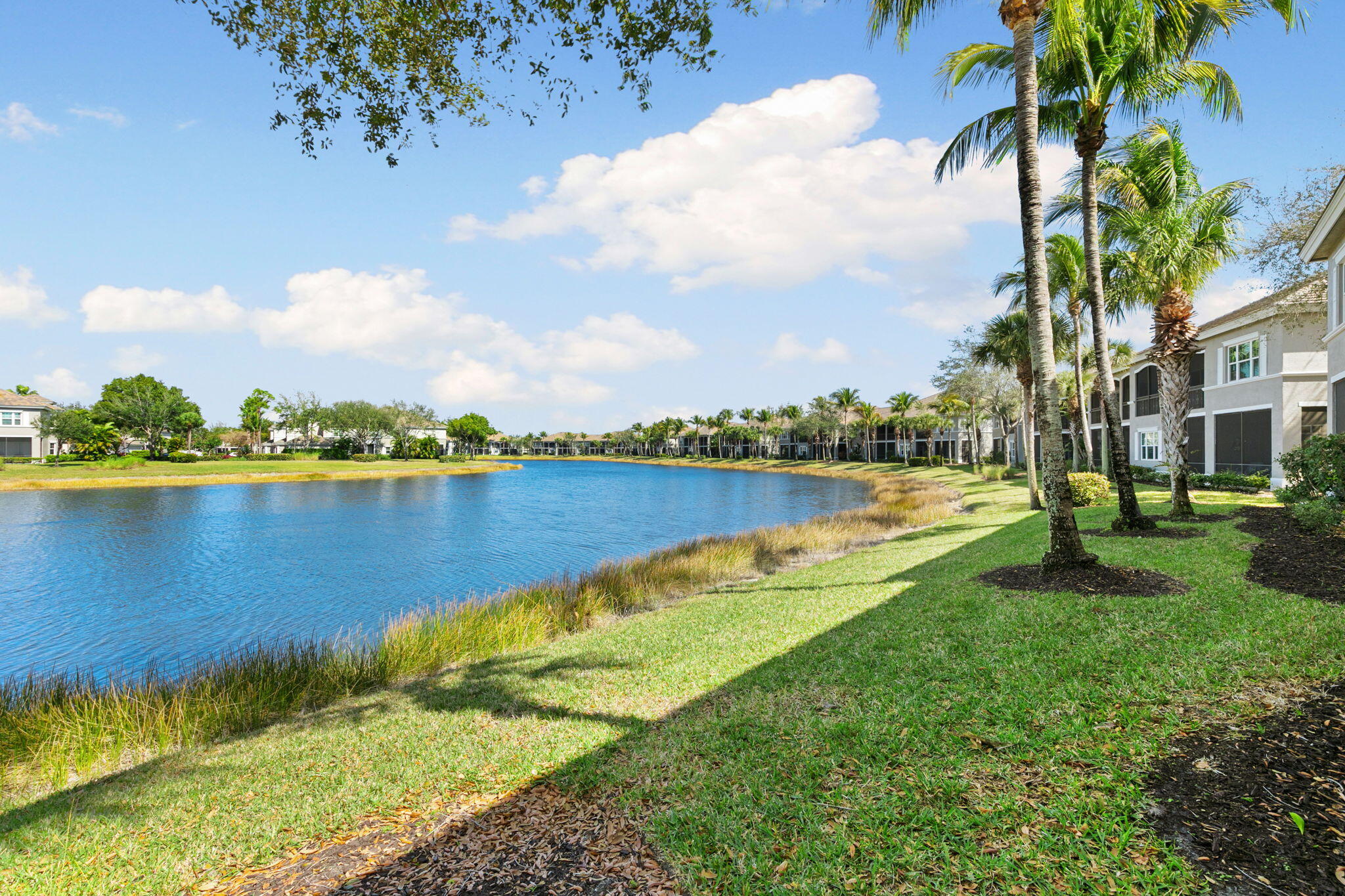 9213 Museo Circle, Unit 103 Naples, FL 34114 - Photo 29 of 47 a view of a lake with houses in the back