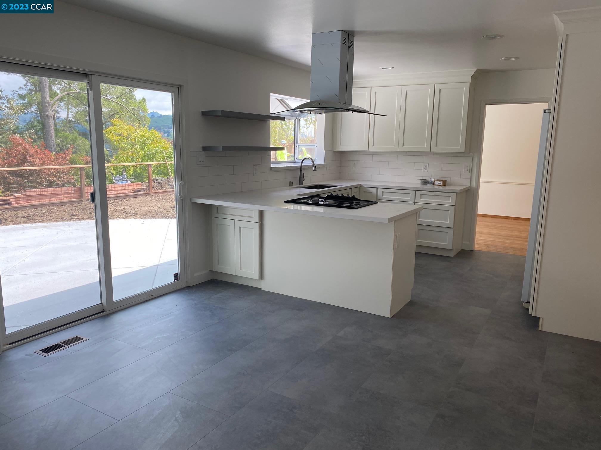 45 Sullivan Drive Moraga, CA 94556 - Photo 5 of 12 a kitchen with a stove a refrigerator and a more cabinets