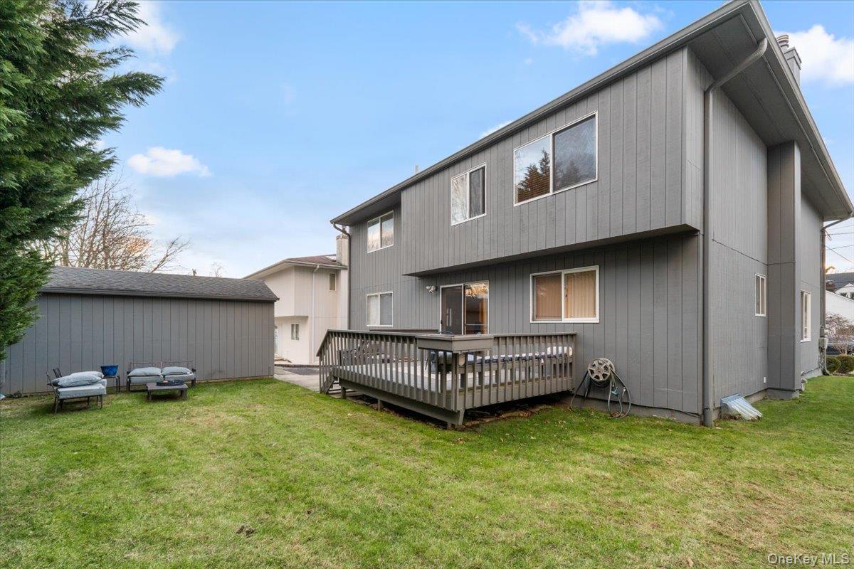 47 Berkshire Road Great Neck, NY 11023 - Photo 36 of 40 Back of house with a deck and a lawn
