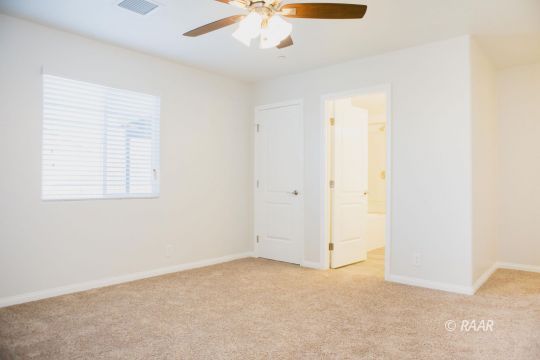 929 South Farragut Street Ridgecrest, CA 93555 - Photo 17 of 35 an empty room with a ceiling fan and a window