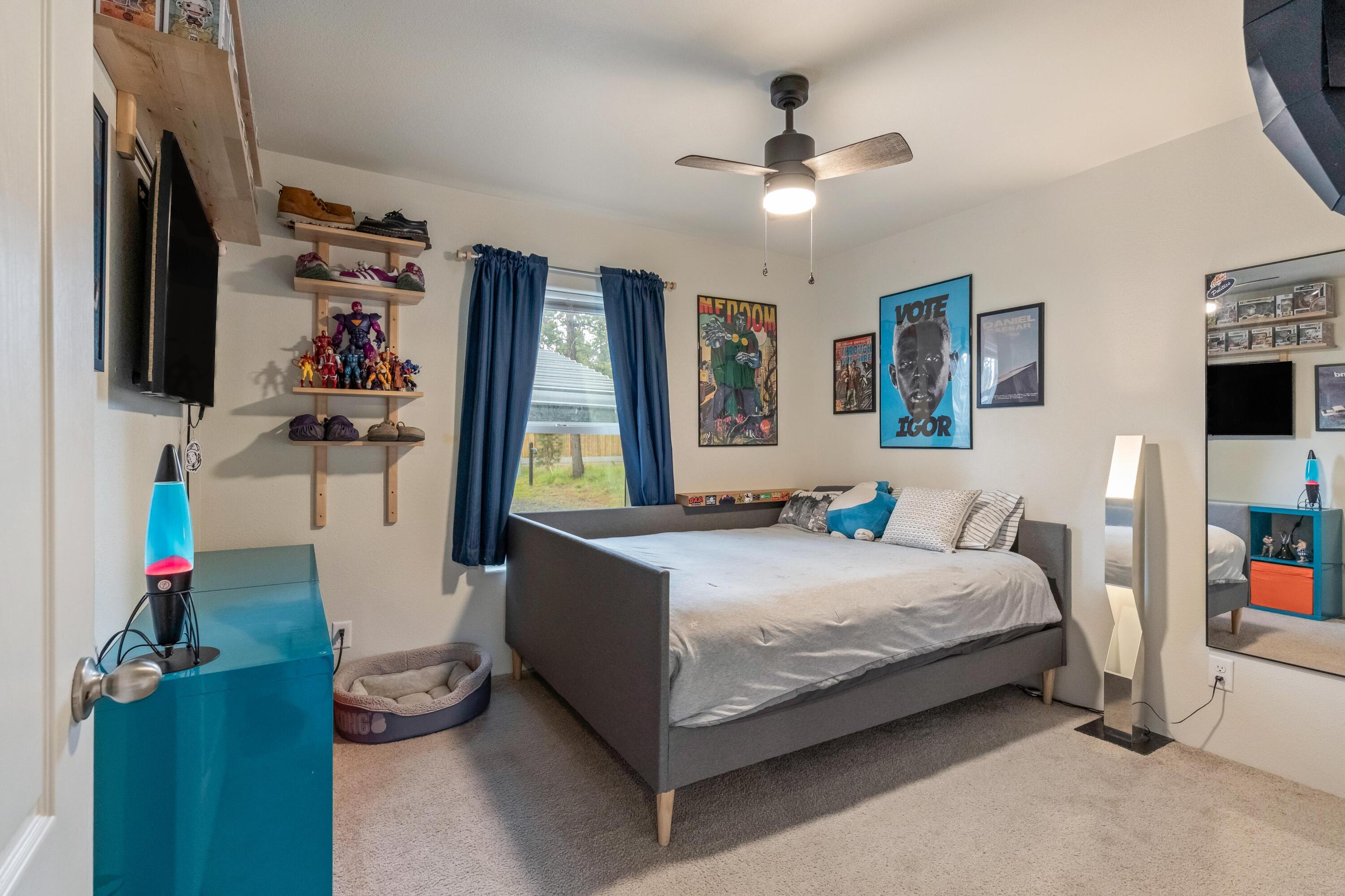 55823 Snow Goose Road Bend, OR 97707 - Photo 16 of 36 a bedroom with a bed couch and window