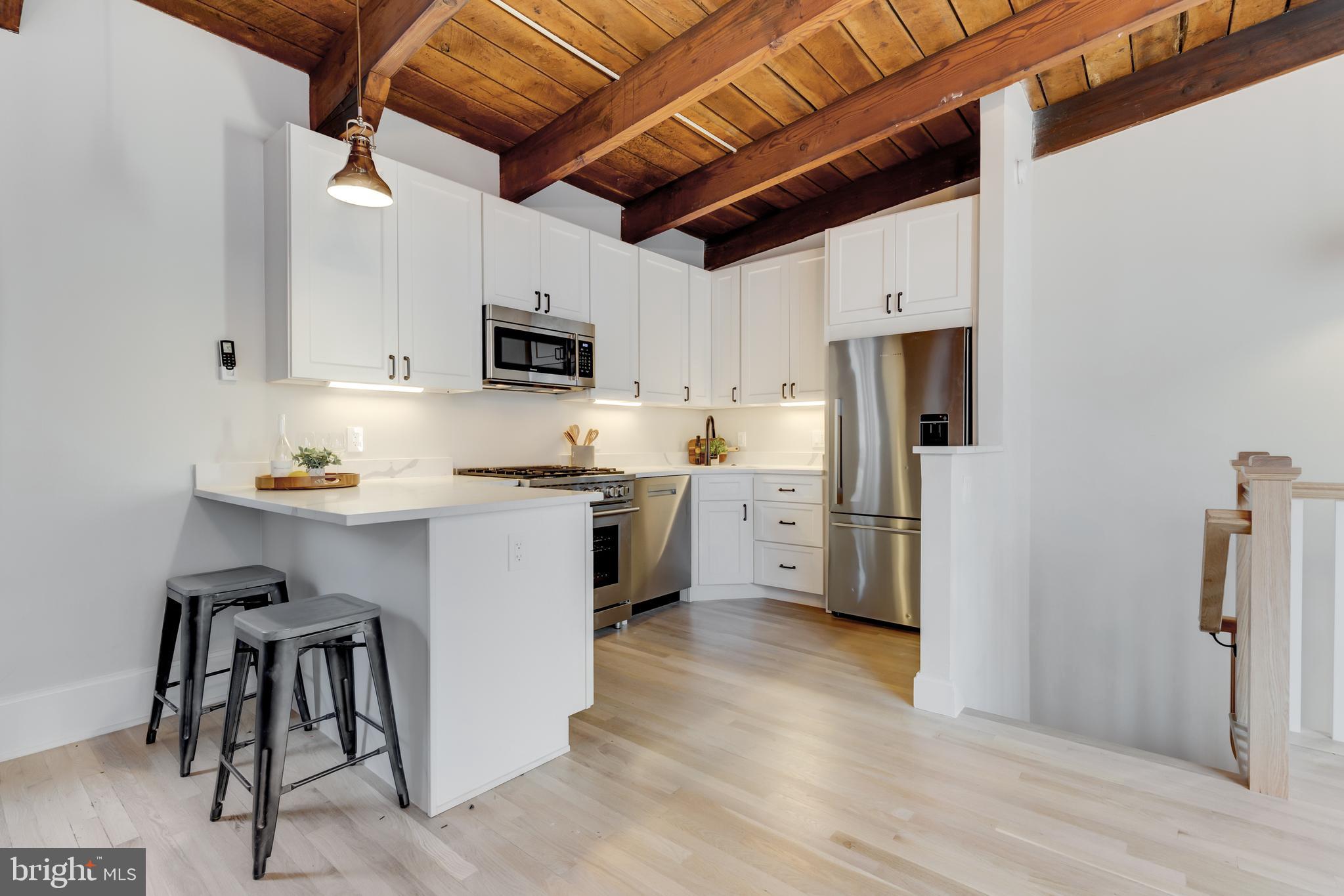 1314 Vermont Avenue Northwest, Unit CH6 Washington, DC 20005 - Photo 11 of 23 a kitchen with a refrigerator a stove top oven a sink and dishwasher