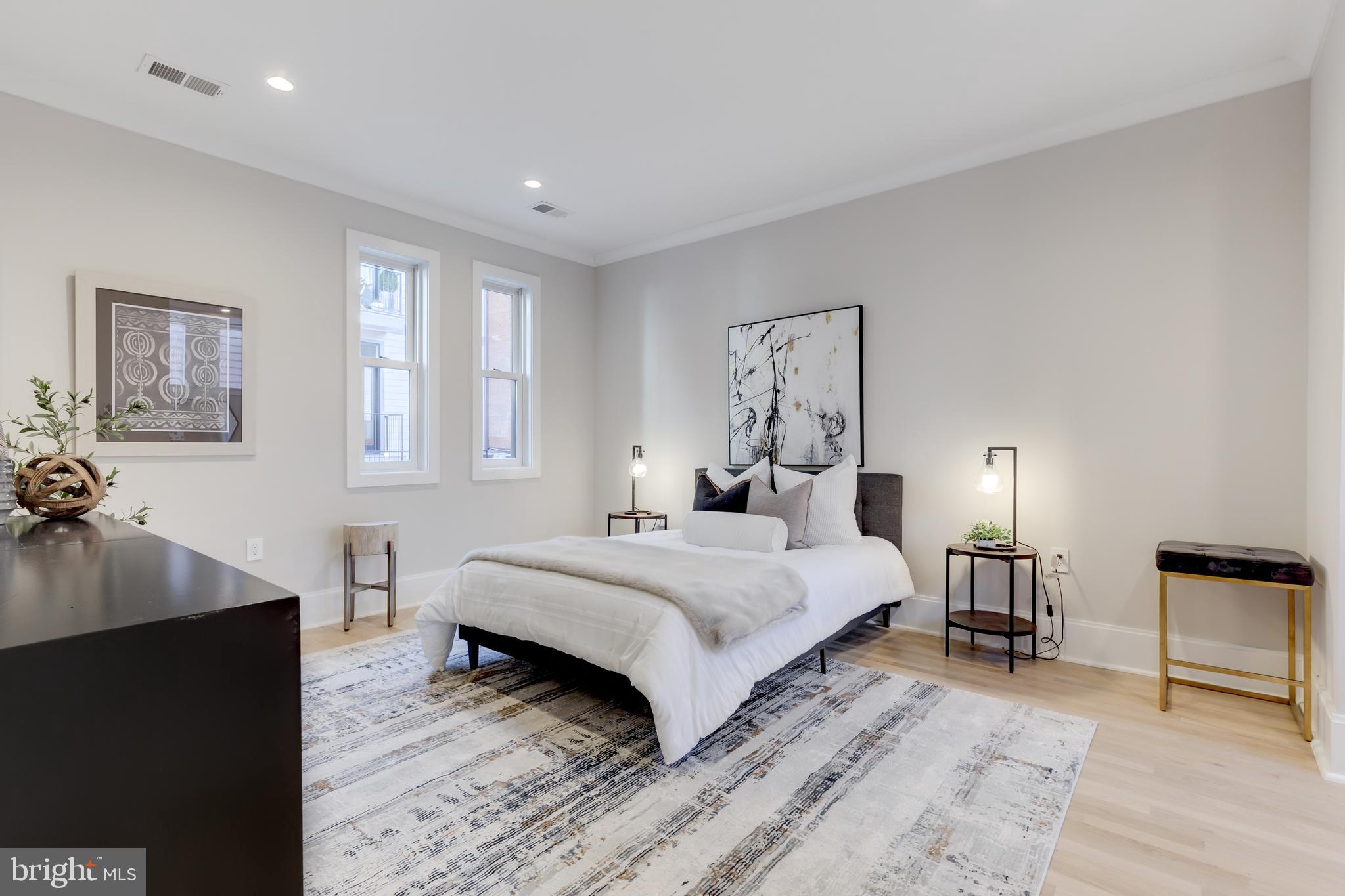 1314 Vermont Avenue Northwest, Unit CH6 Washington, DC 20005 - Photo 16 of 23 a bedroom with a bed and wooden floor