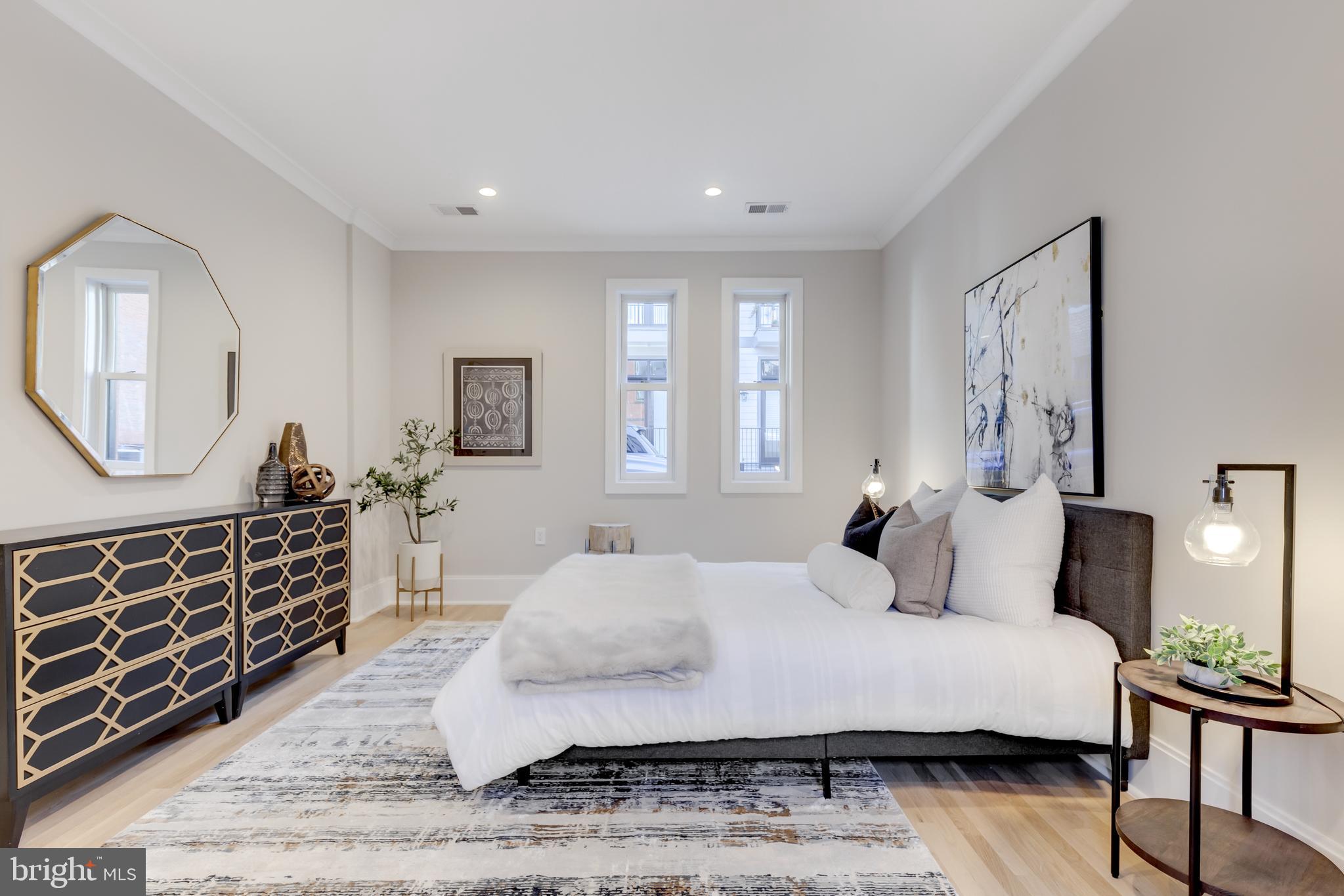 1314 Vermont Avenue Northwest, Unit CH6 Washington, DC 20005 - Photo 17 of 23 a bedroom with a large bed and a dresser