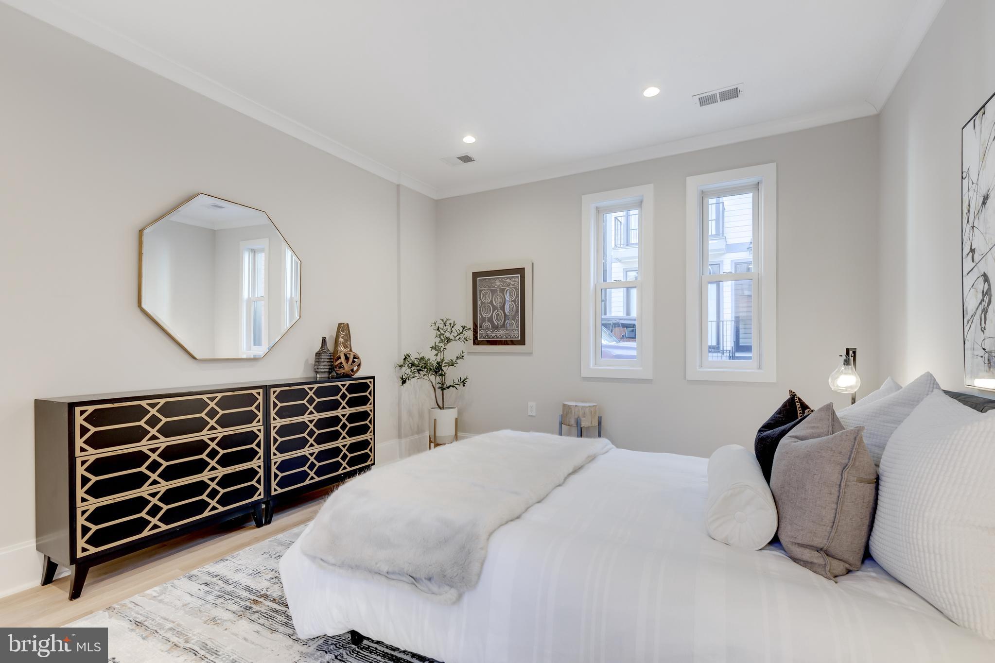 1314 Vermont Avenue Northwest, Unit CH6 Washington, DC 20005 - Photo 18 of 23 a bedroom with a bed and a dresser