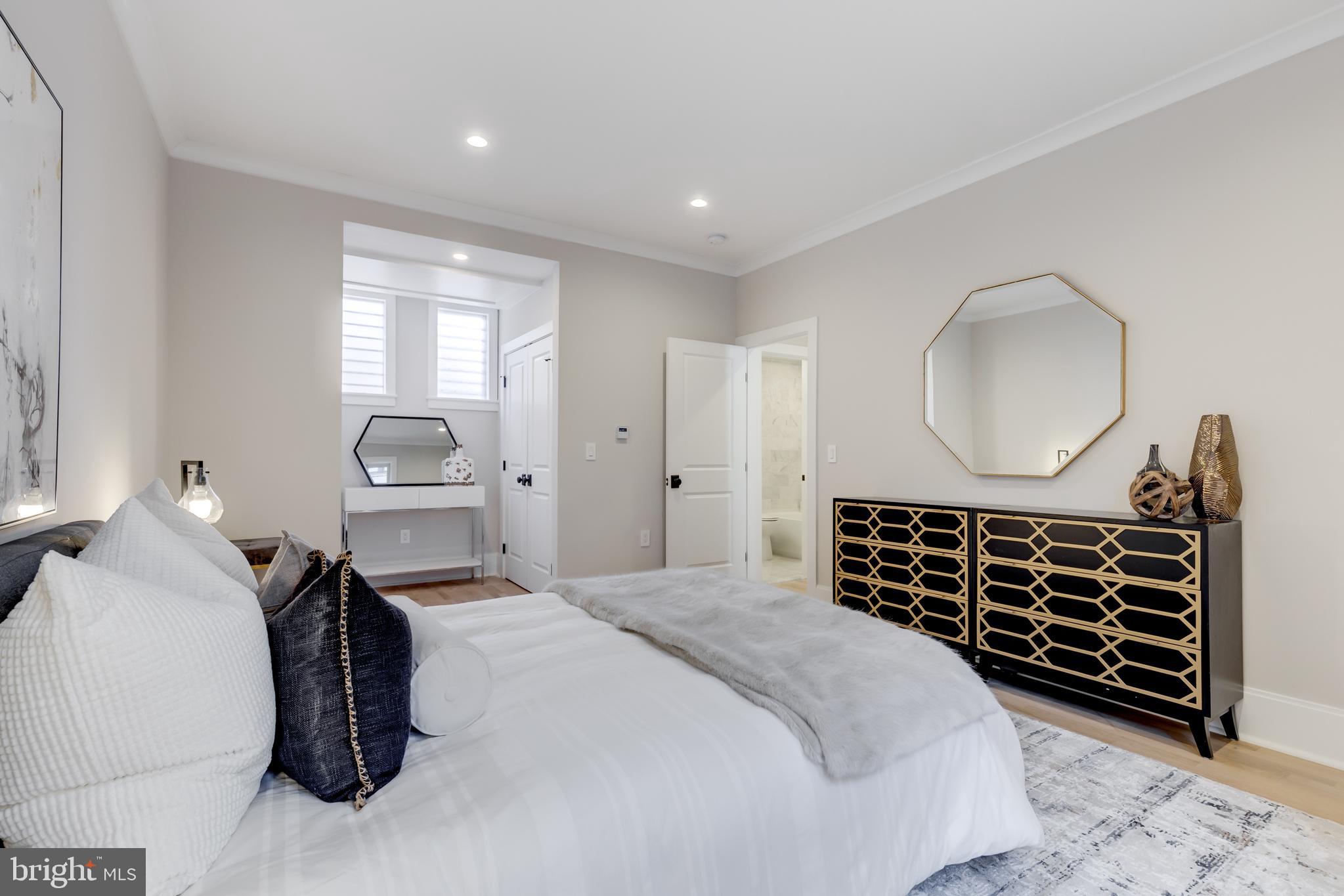 1314 Vermont Avenue Northwest, Unit CH6 Washington, DC 20005 - Photo 20 of 23 a bedroom with bed and a chandelier