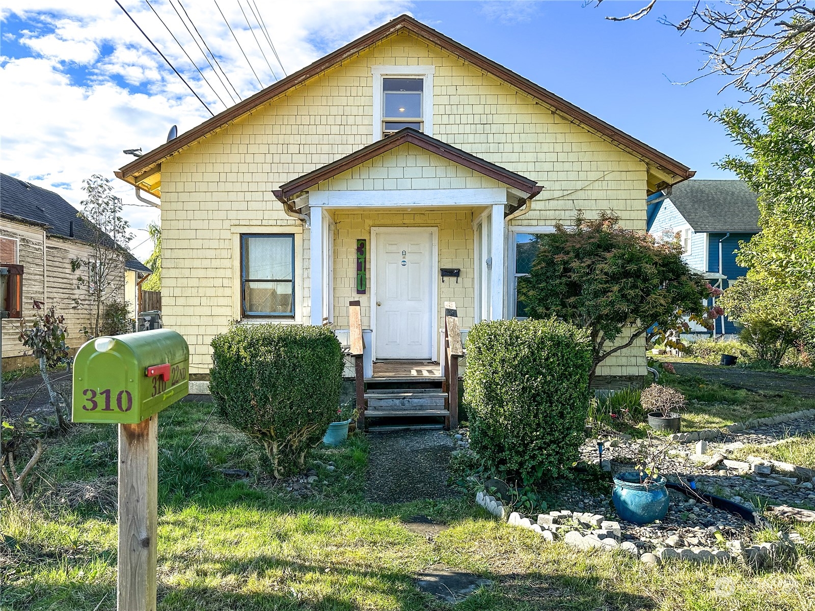 a front view of a house with garden