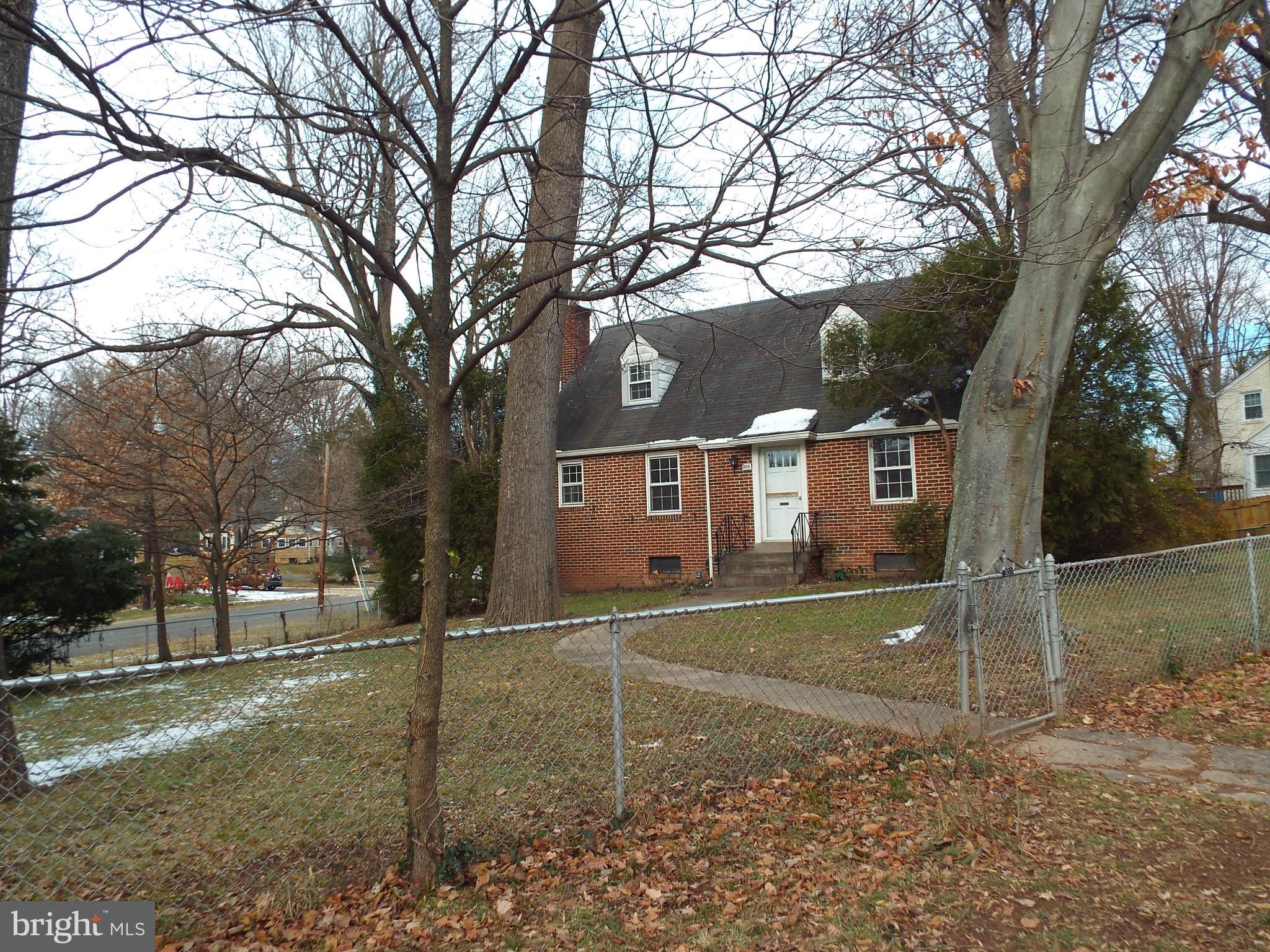 a view of a large trees in front of a house