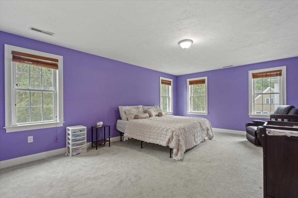 28 McIntosh Drive, Unit 22 Stow, MA 01775 - Photo 20 of 38 a bed room with a bed and a chair