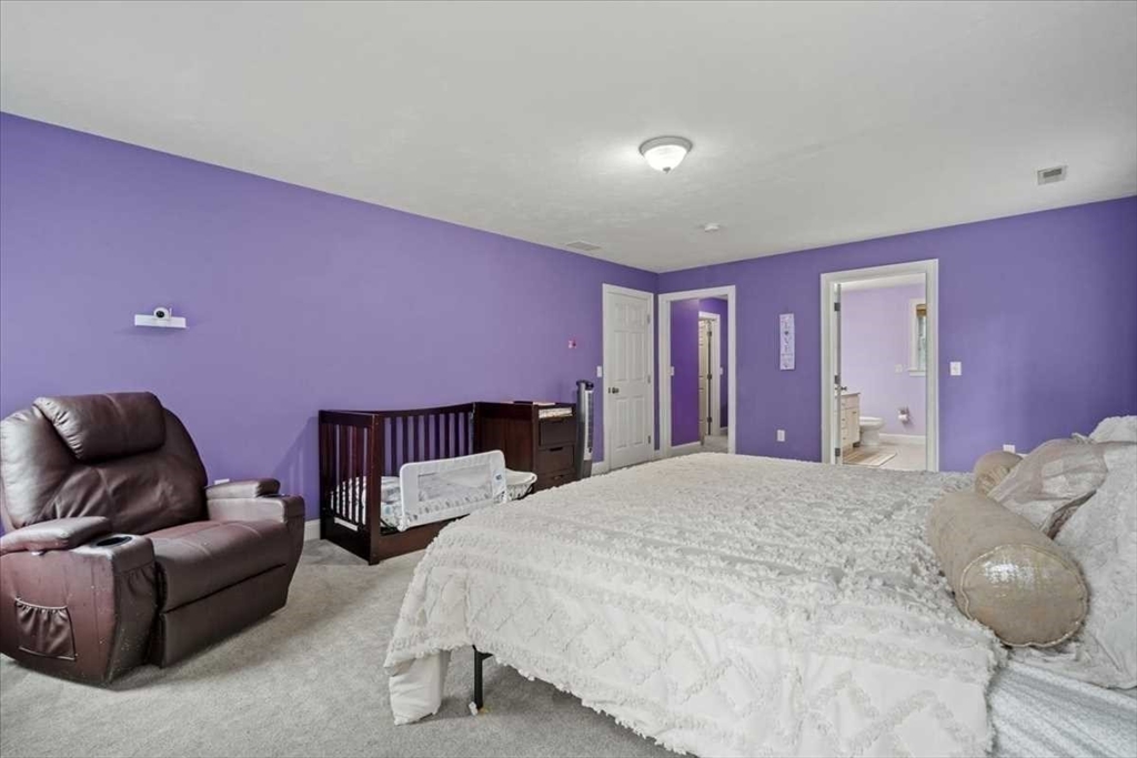 28 McIntosh Drive, Unit 22 Stow, MA 01775 - Photo 22 of 38 a bed room with a bed and a couch