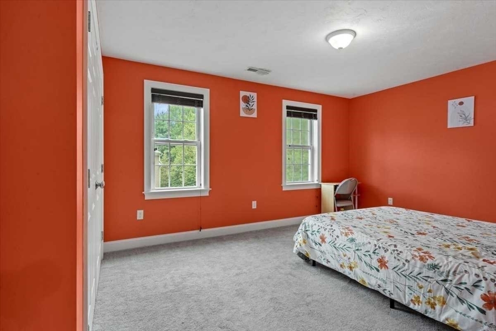 28 McIntosh Drive, Unit 22 Stow, MA 01775 - Photo 27 of 38 a bedroom with bed and window