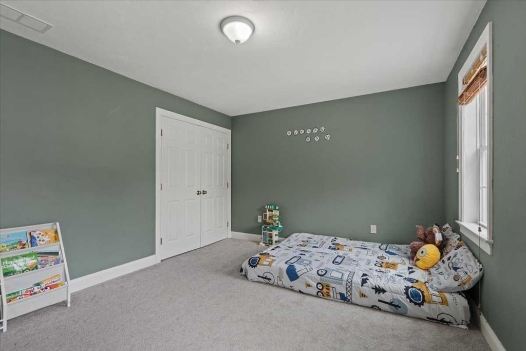 28 McIntosh Drive, Unit 22 Stow, MA 01775 - Photo 29 of 38 a bedroom with a bed and a window