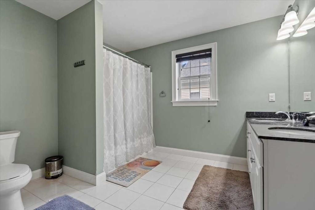 28 McIntosh Drive, Unit 22 Stow, MA 01775 - Photo 30 of 38 a bathroom with a sink toilet and shower