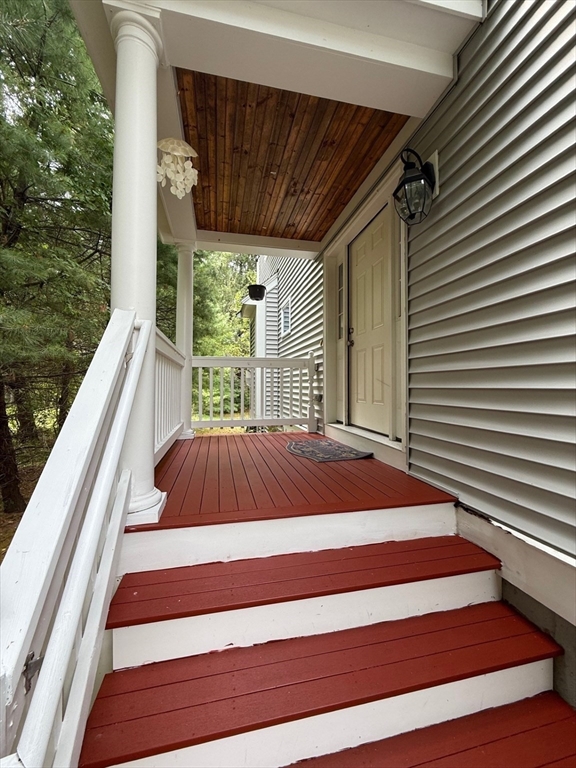 28 McIntosh Drive, Unit 22 Stow, MA 01775 - Photo 3 of 38 a view of backyard with hardwood and deck